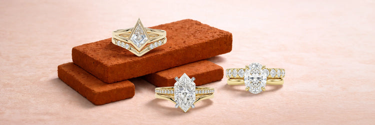 Three lab-grown diamond bridal ring sets in yellow gold — kite cut with chevron wedding band on terracotta bricks, marquise cut solitaire with pavé band, and oval cut three-stone ring with matching diamond band