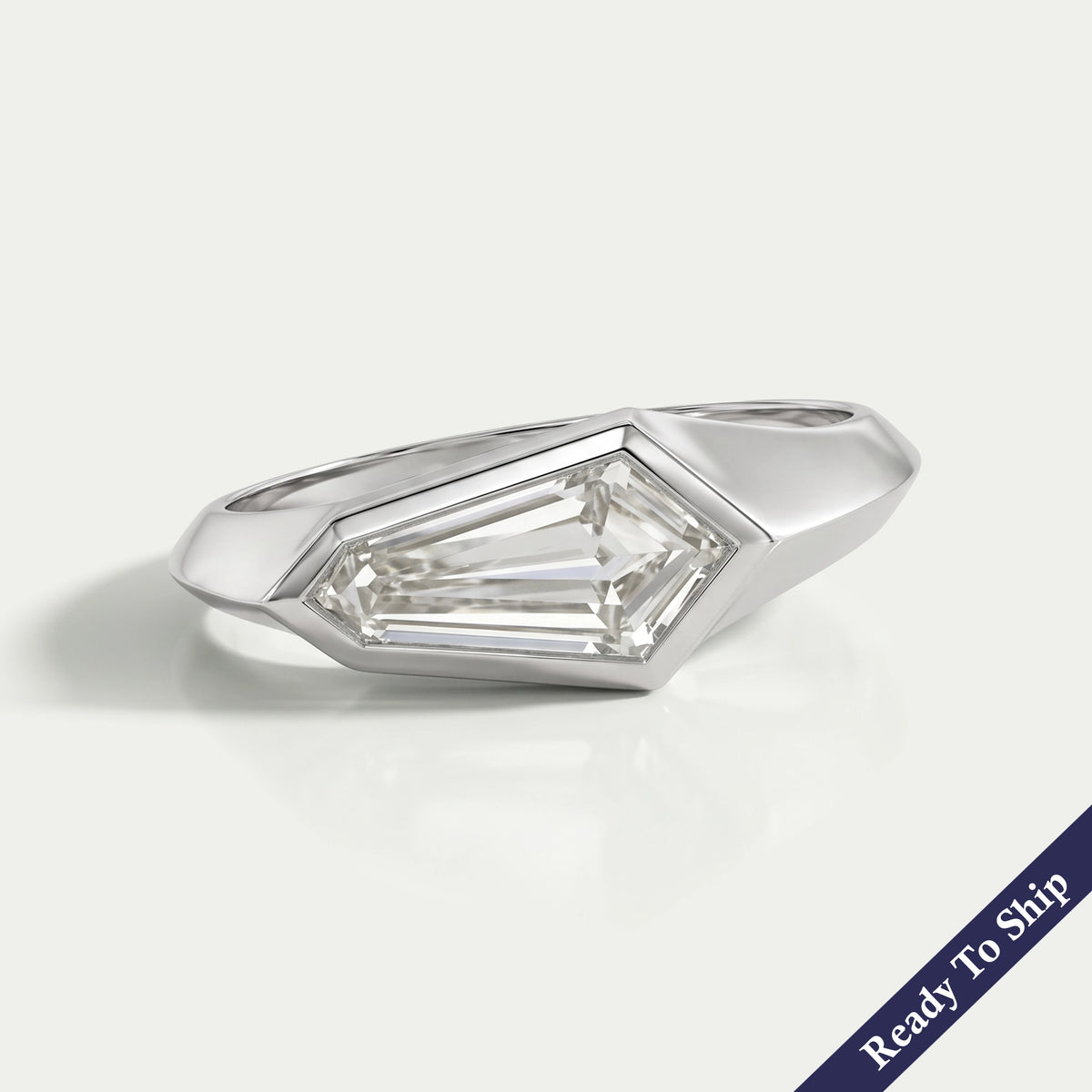 East West Step Cut Shield Bezel Set Solitaire Ring